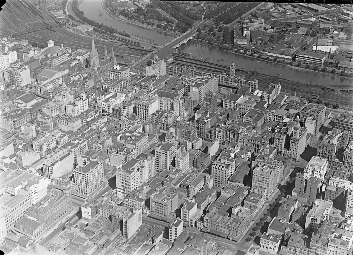 Looking over City of Melbourne towards Flinders Street, Yarra River and Rail Yards, Melbourne City (c. 1948)