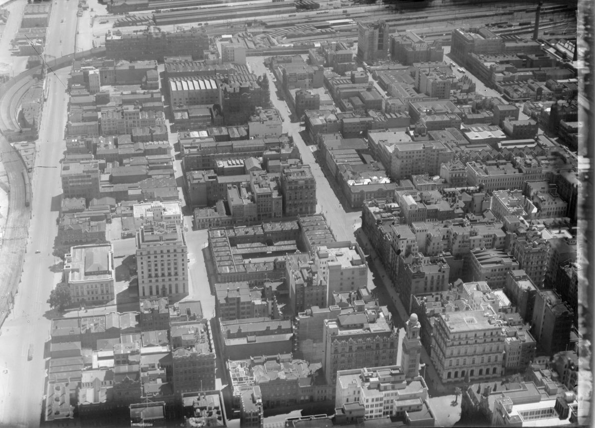 City of Melbourne, Flinders Street on left, looking towards Spencer Street Rail Yards at top of image, Melbourne City (1926–28)