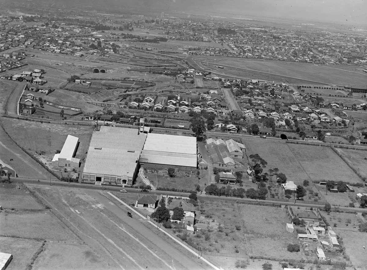 Albion Street, West Brunswick, showing factories and houses with Moonee Valley racecourse in right background, Brunswick West (1928)