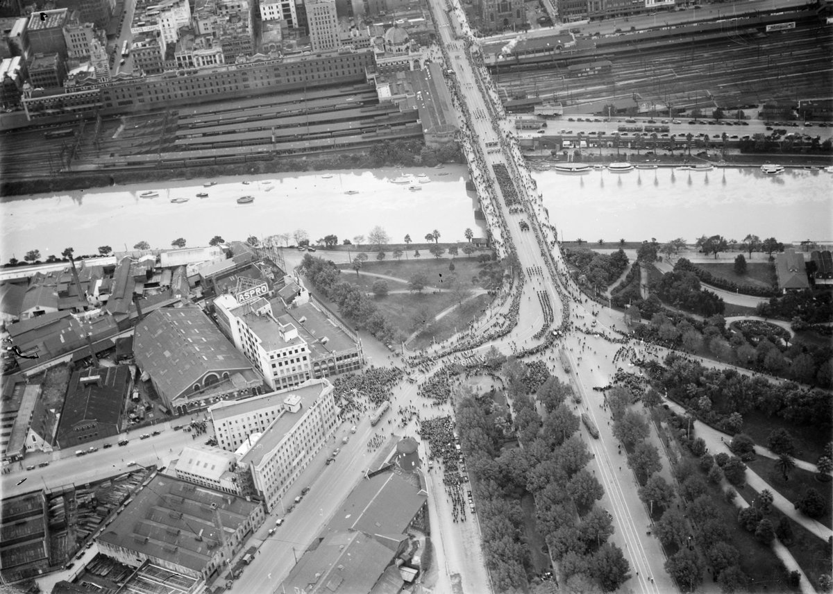 Procession in Swanston Street from south bank of Yarra River at Princes Bridge, showing Aspro building in City Road, Melbourne City (c. 1945)