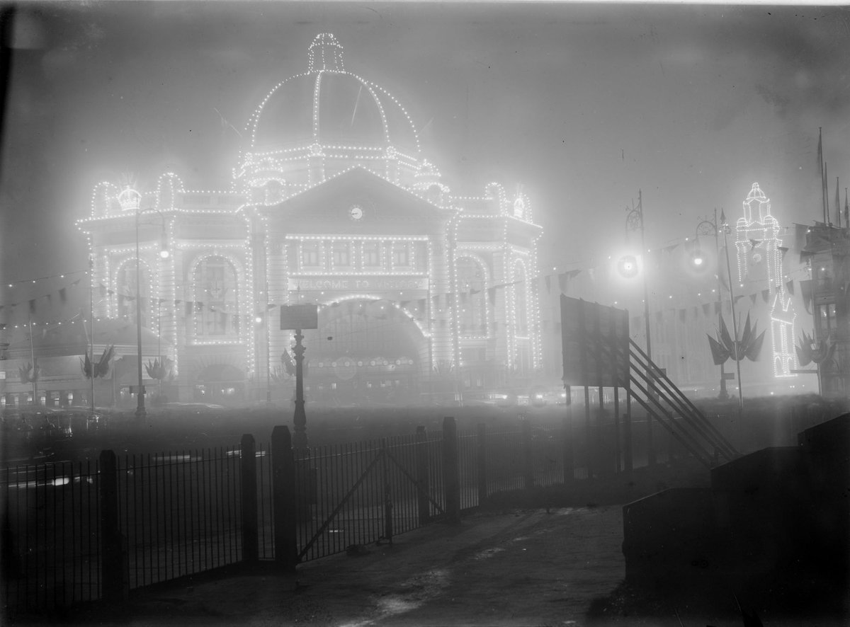 Flinders Street station illuminated at night, Melbourne City (1900–29)