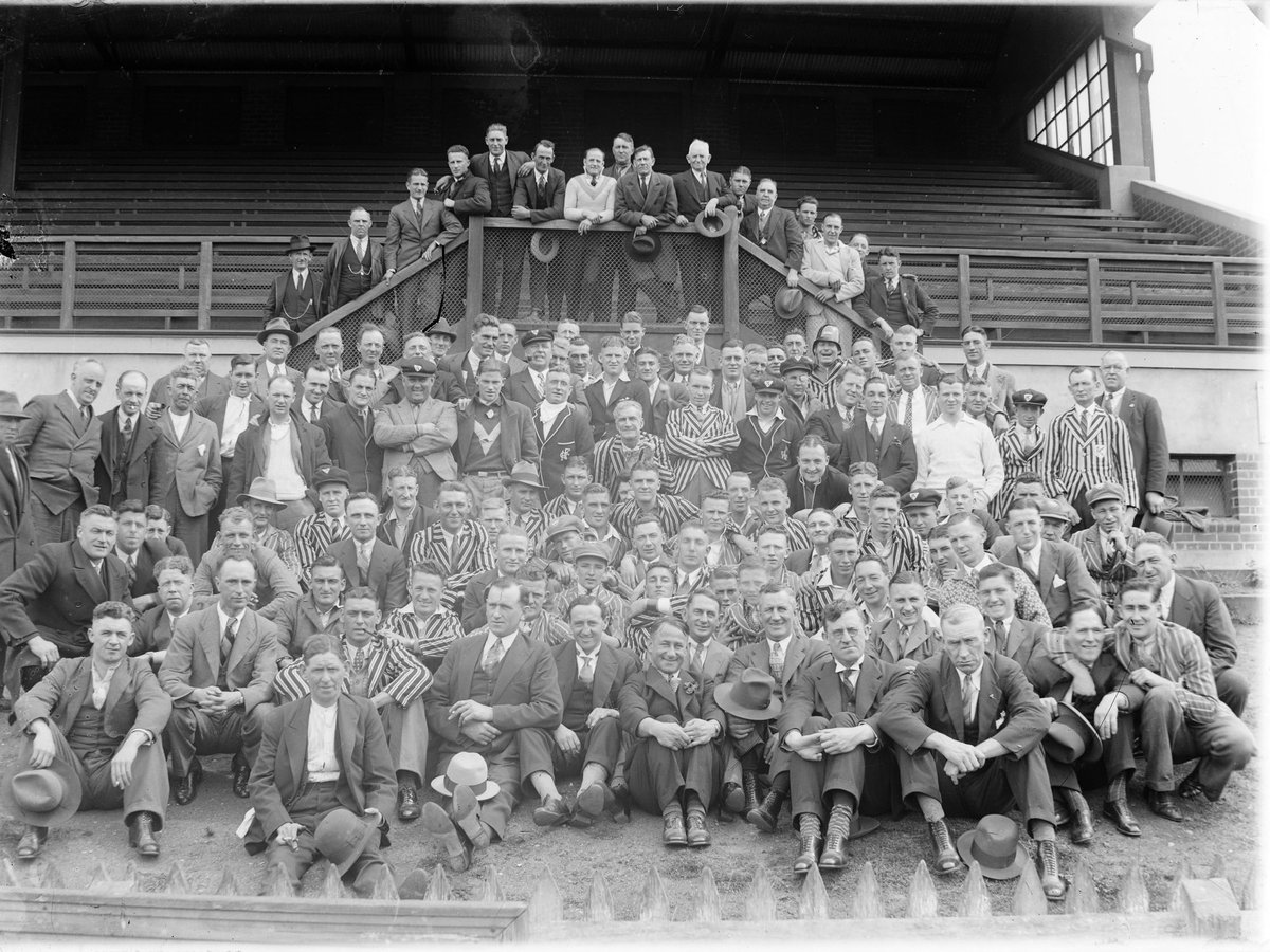 [Arthur Calwell with (possibly) North Melbourne past players, in front of grandstand] (1940–50)