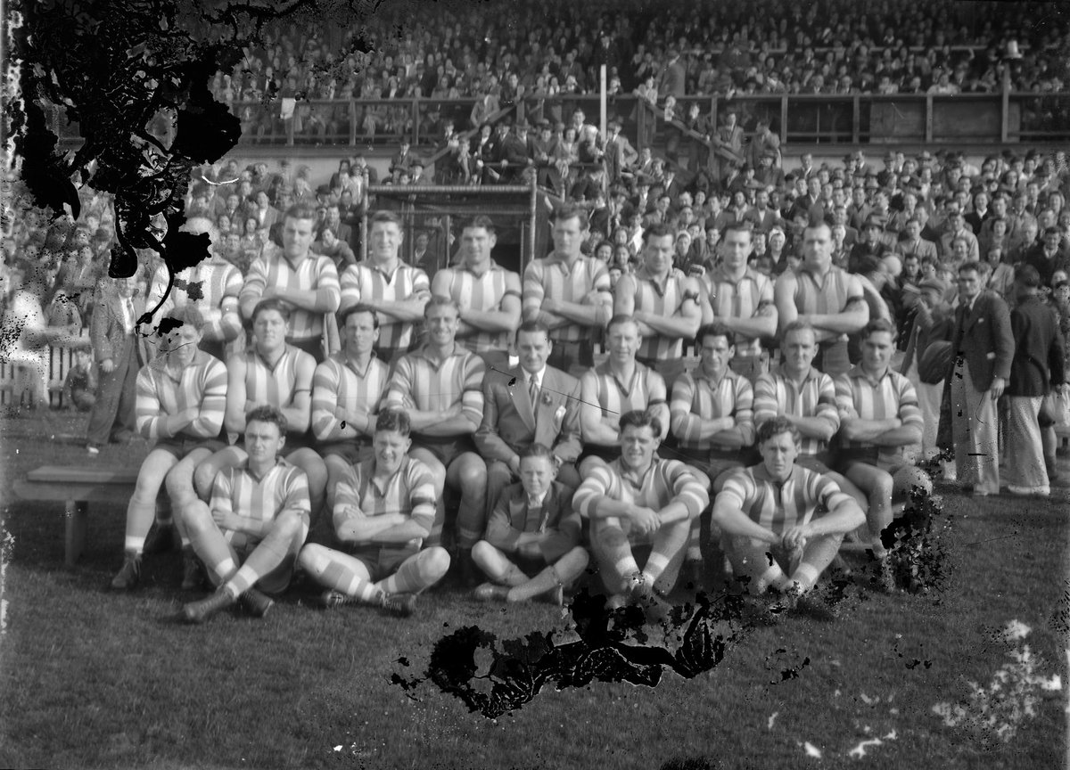 North Melbourne (VFL) football team in front of a grandstand (c. 1949)