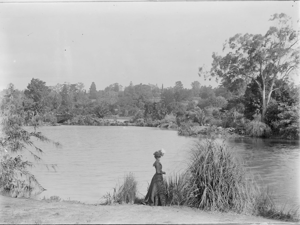 Lady standing by the lake, Botanical Gardens, Melbourne, Melbourne City (c. 1900)