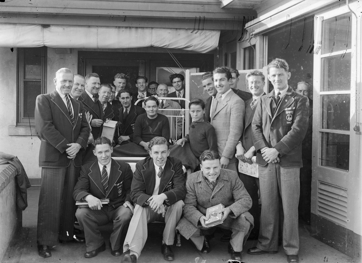 South Melbourne football players visiting a boy in hospital (1947?)