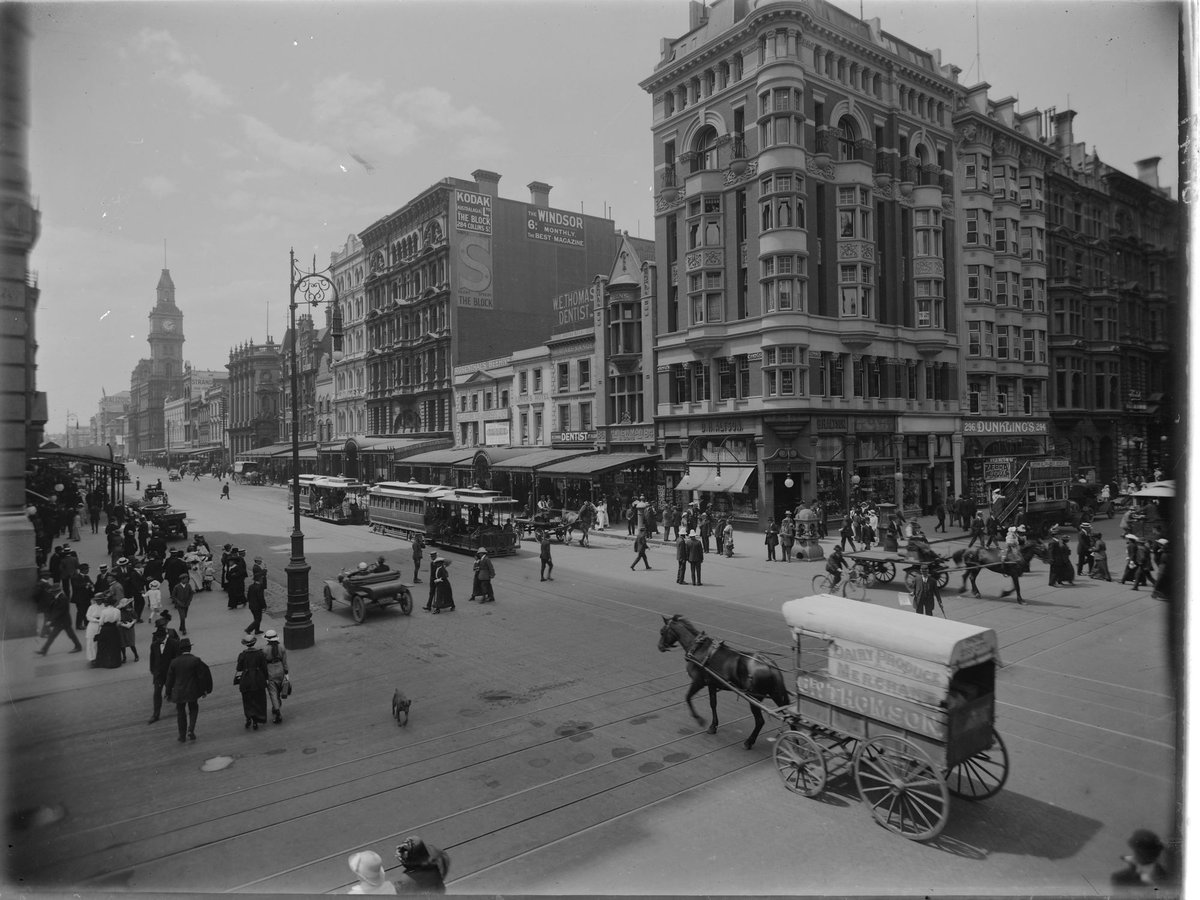 Intersection of Collins and Elizabeth Streets, Melbourne, from south east corner, showing horse-drawn vehicles, cable trams, cars and pedestrians, Melbourne City (1910–20)