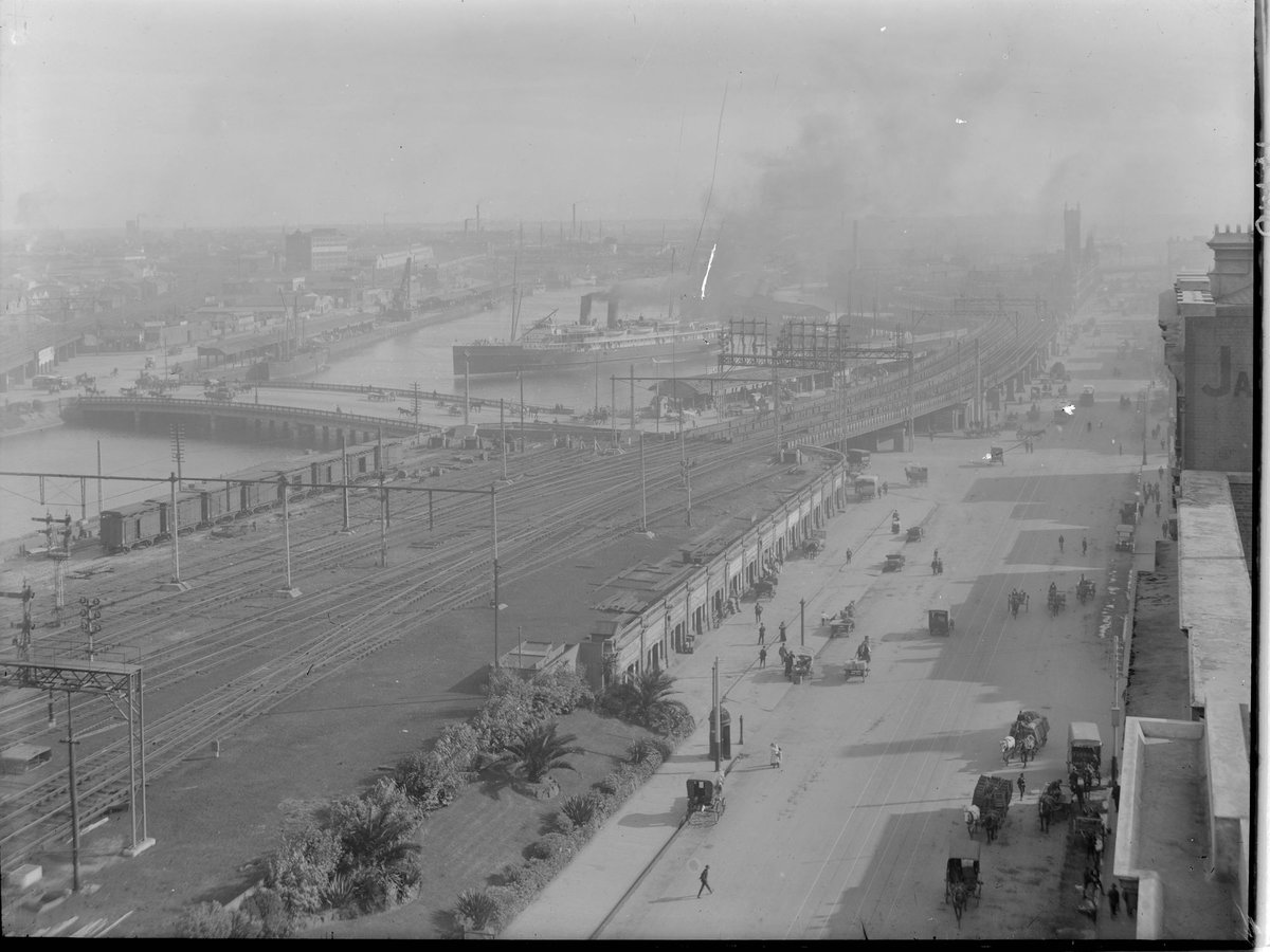 Elevated view along Flinders Street, Melbourne, looking over railway yards, Yarra River and wharves, Melbourne City (1910–20)