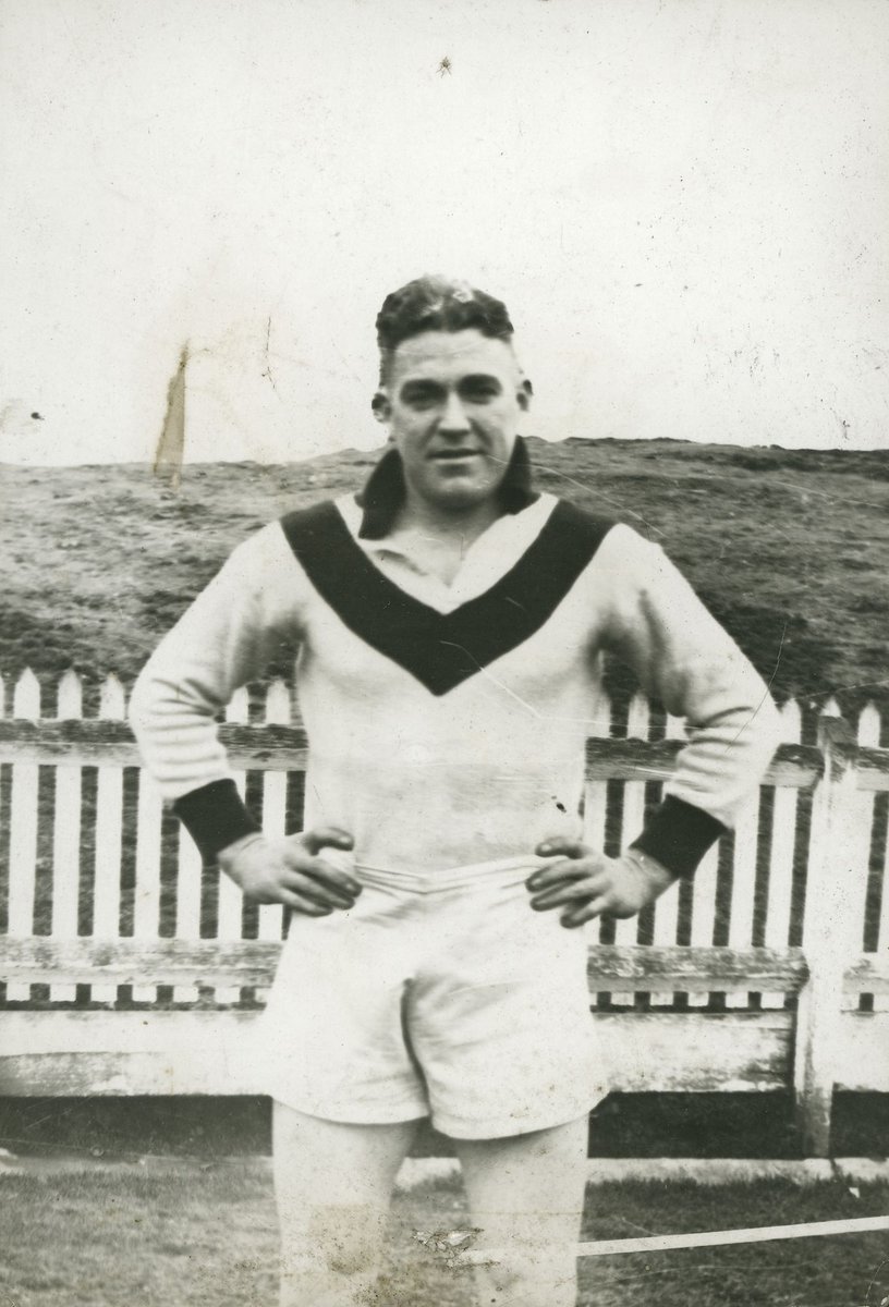 Two South Melbourne football players, Eddie Lane and an unidentified player, standing on field (1951–54)