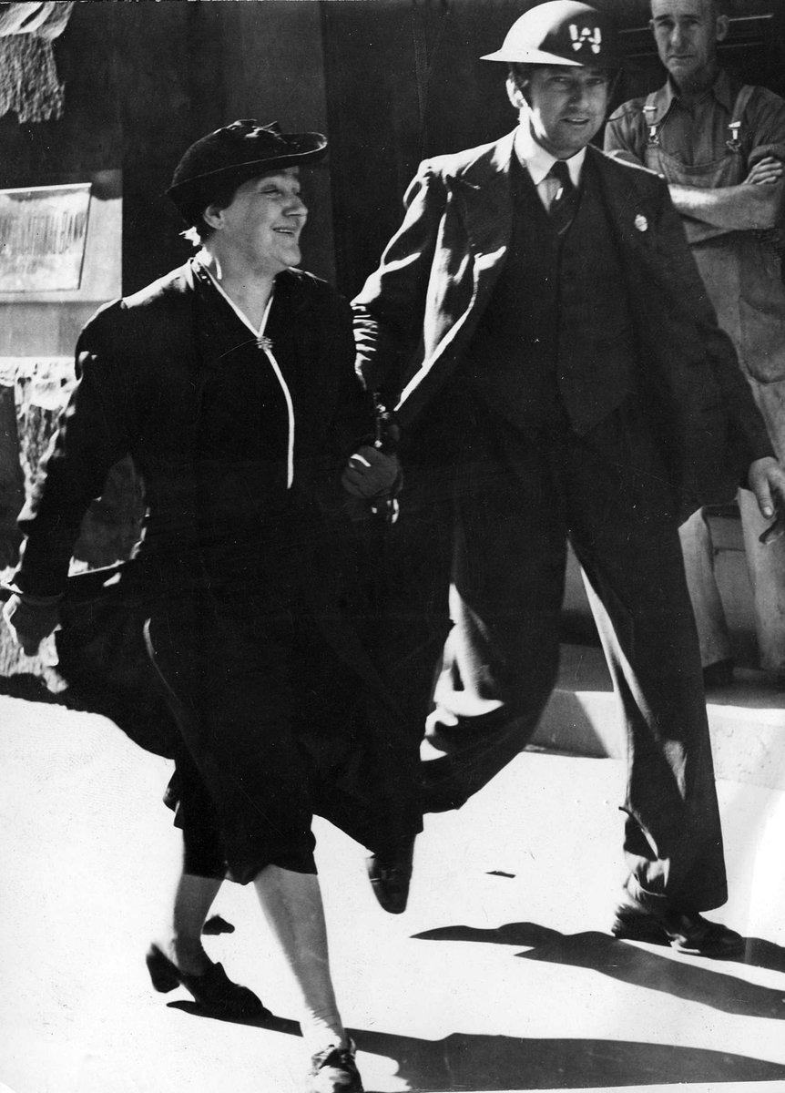 A warden conducting a pedestrian to a shelter in Collins St, Melbourne City (c. 1942)
