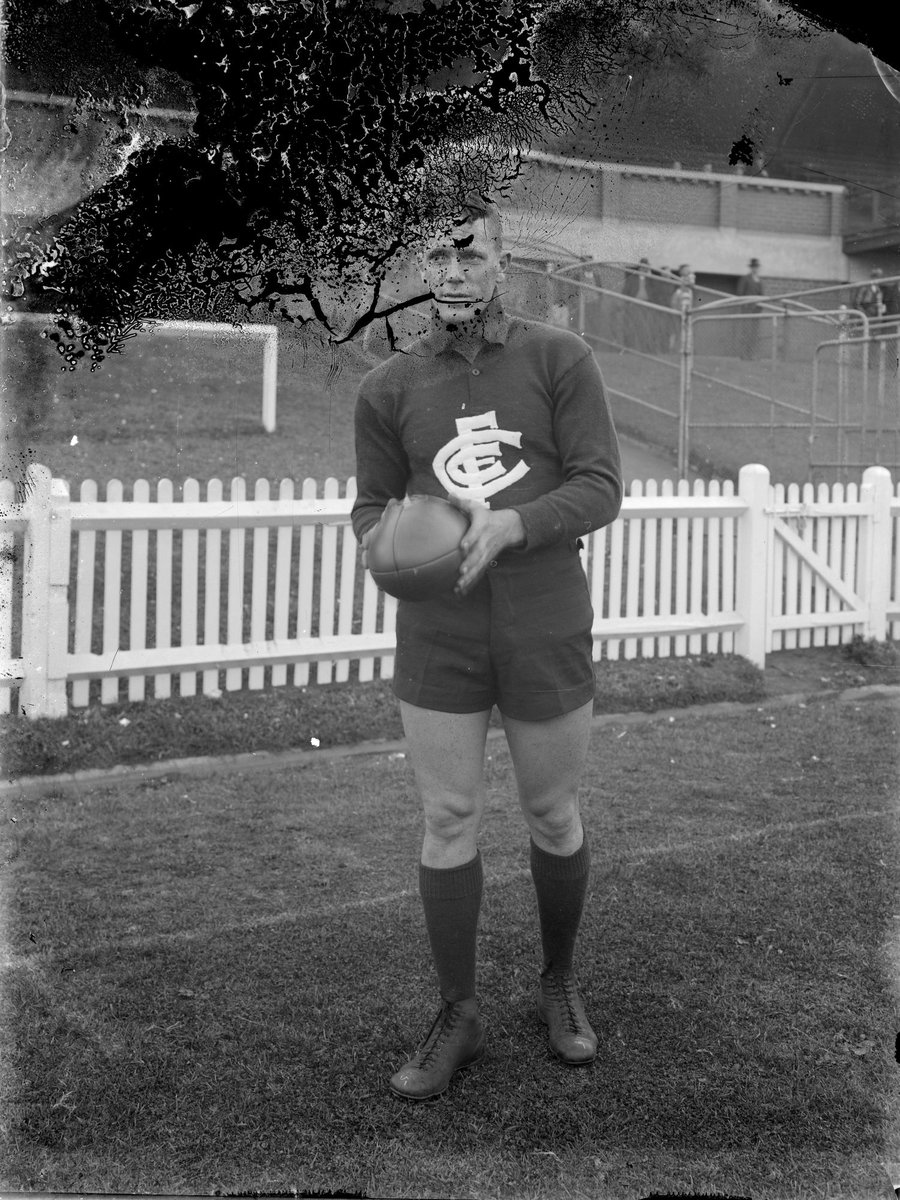 Carlton Football Club player in front of a grandstand (1920–50)