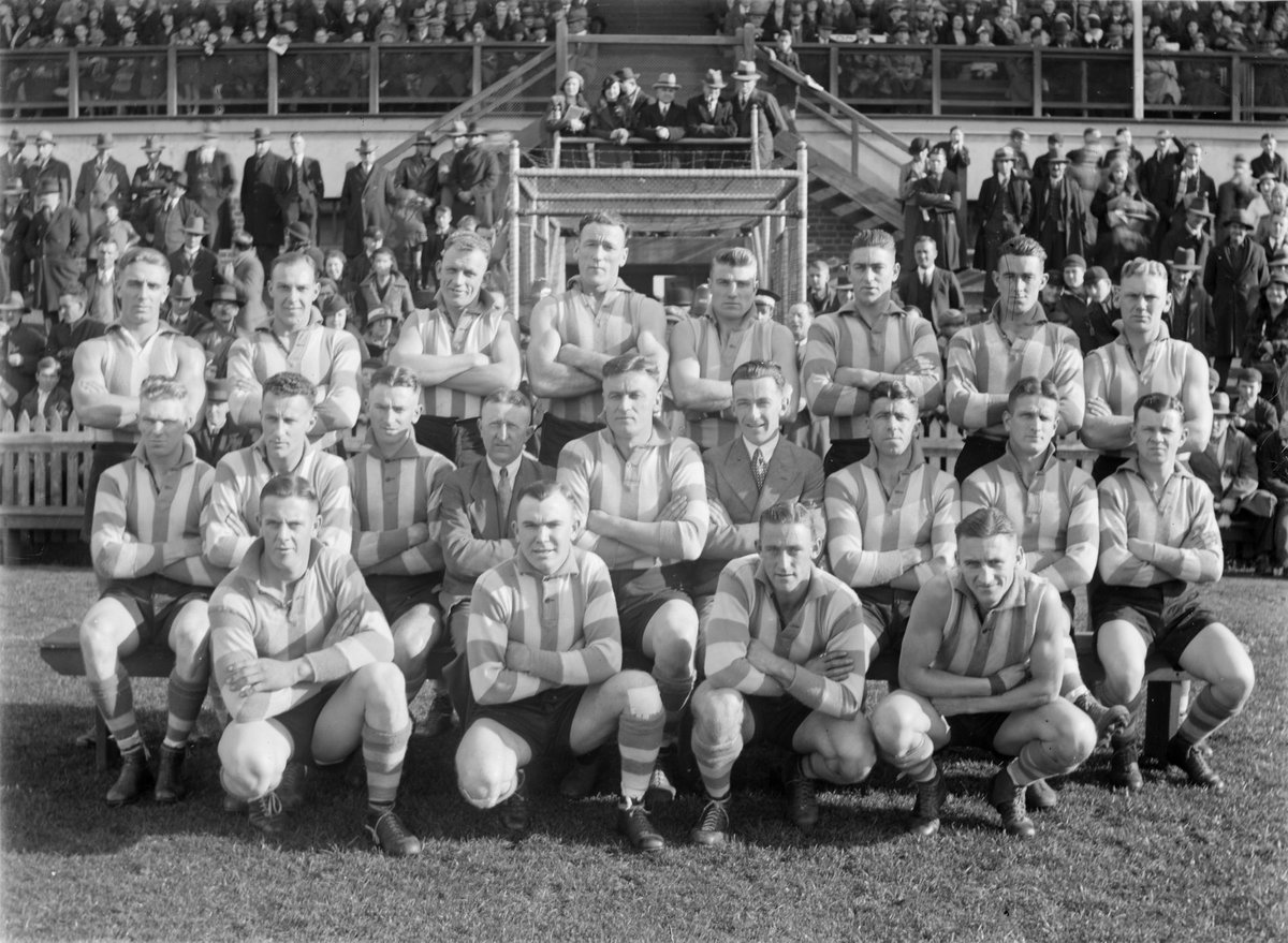 North Melbourne (VFL) football team in front of a grandstand, Arden Street (1934–35)