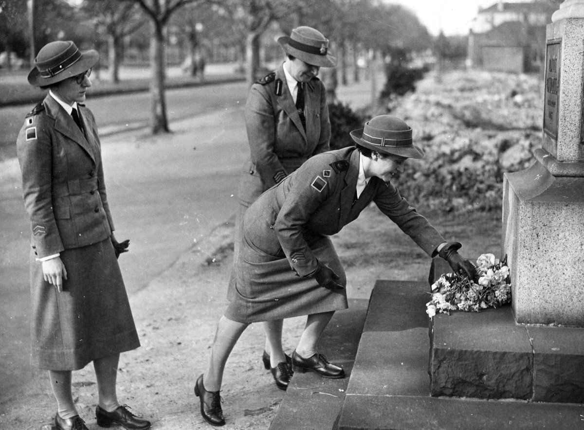 Nurses laying flowers on the Edith Cavell Memorial, St. Kilda Road, Melbourne, Melbourne City (c. 1943)