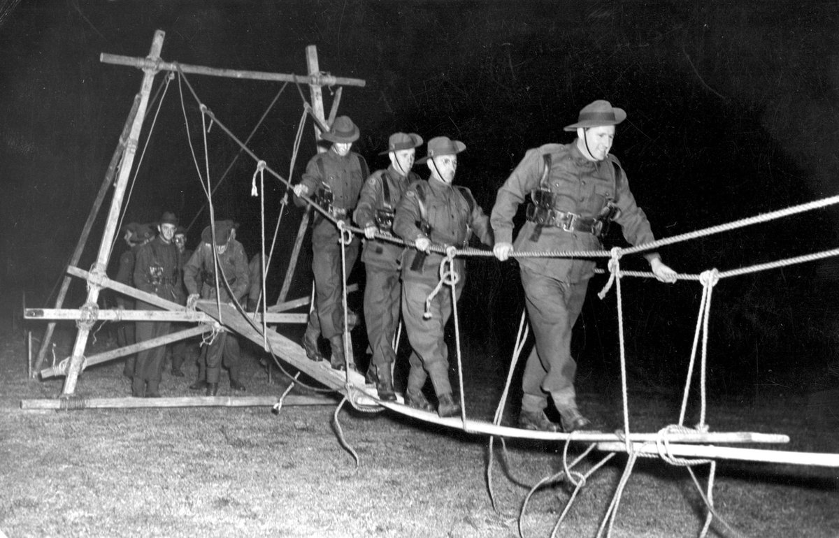V.D.C. at East Malvern testing out their [illegible] built rope and plank bridge, Malvern East (c. 1943)