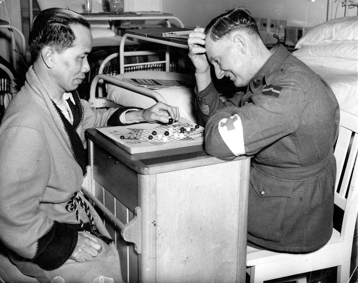 Mr Cheonglan of Merchant Navy is a Chinese at present in Heidelberg Military hospital. He is seen playing checkers with his hospital orderly (c. 1942)