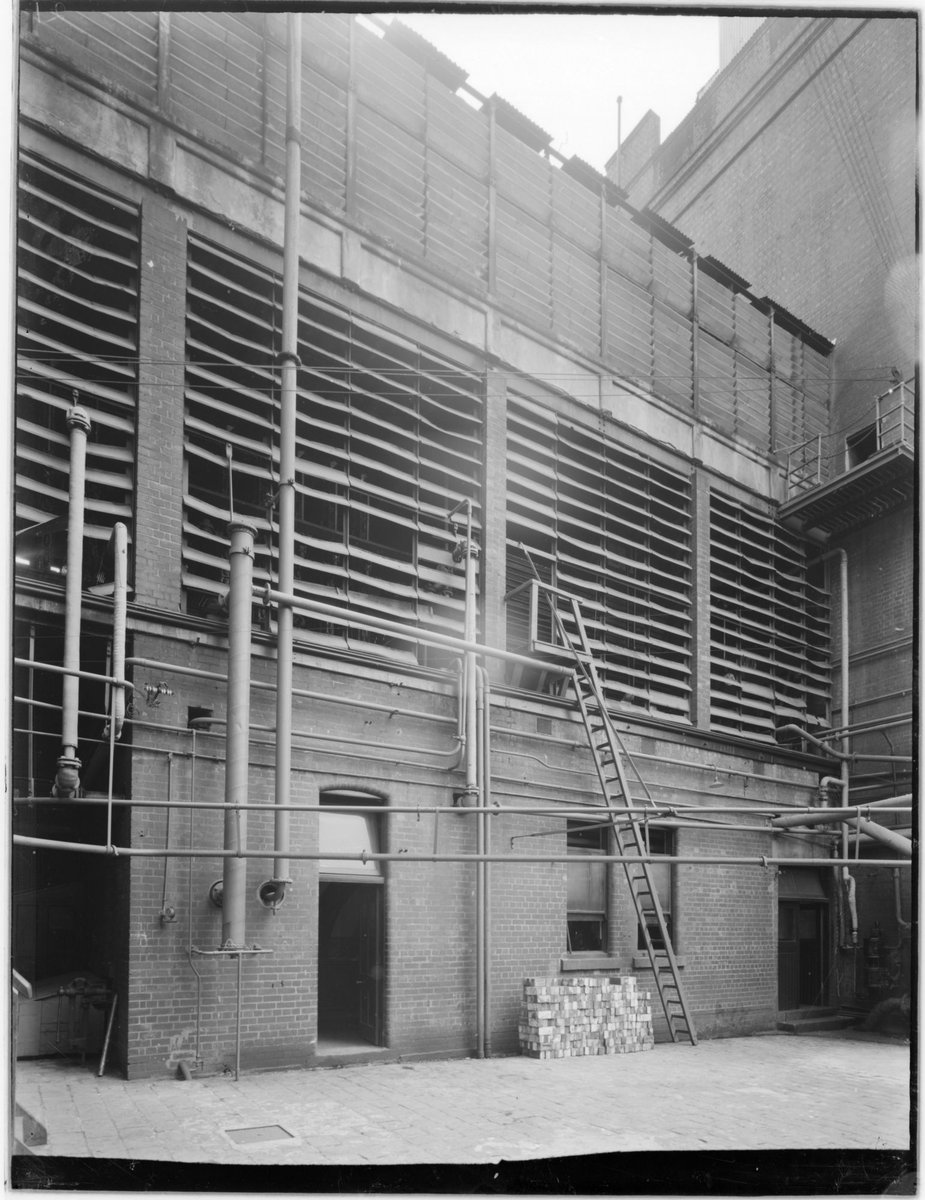 Carlton Brewery. Exterior of No.1 engine room and spraying tower from [the] yard of the boiler house (1938)