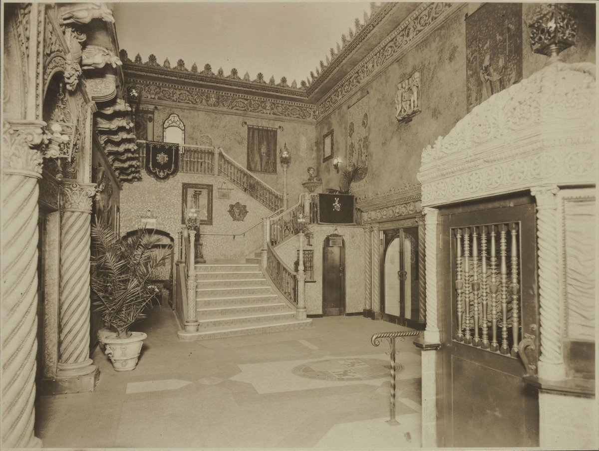 View towards stairs to dress circle from the entrance foyer of the State Theatre Melbourne, showing gargoyles along underside of the balcony (1929)