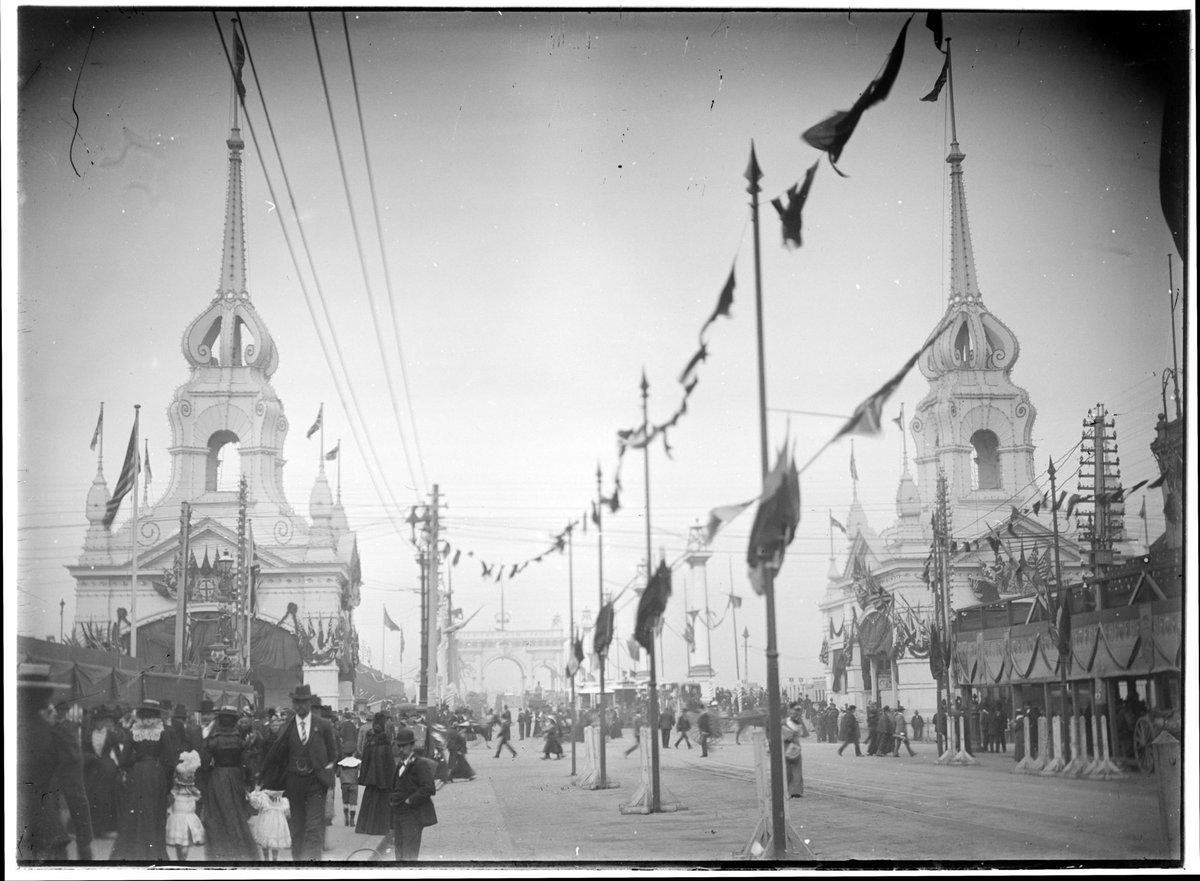 Swanston Street decorated with flags, arch over Princes Bridge in background, Melbourne City (c. 1901)
