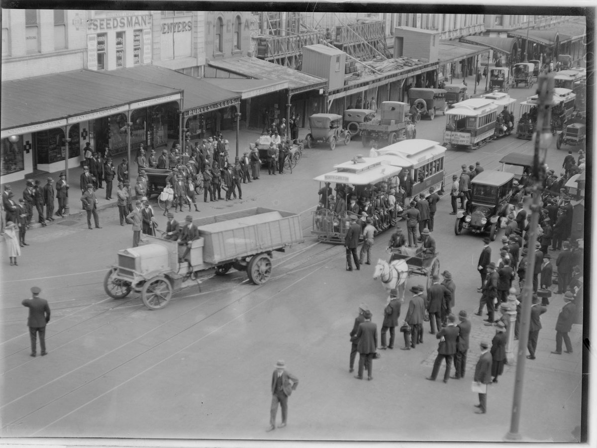 Procession of truck in front of North Carlton tram being watched by a large group of people, Carlton North (1902–20)