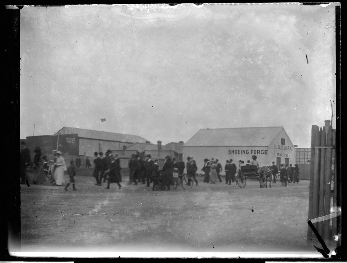 Crowd of people and horse carriage on street, going to Collingwood football match, Victoria Park, Collingwood (1890–1920)