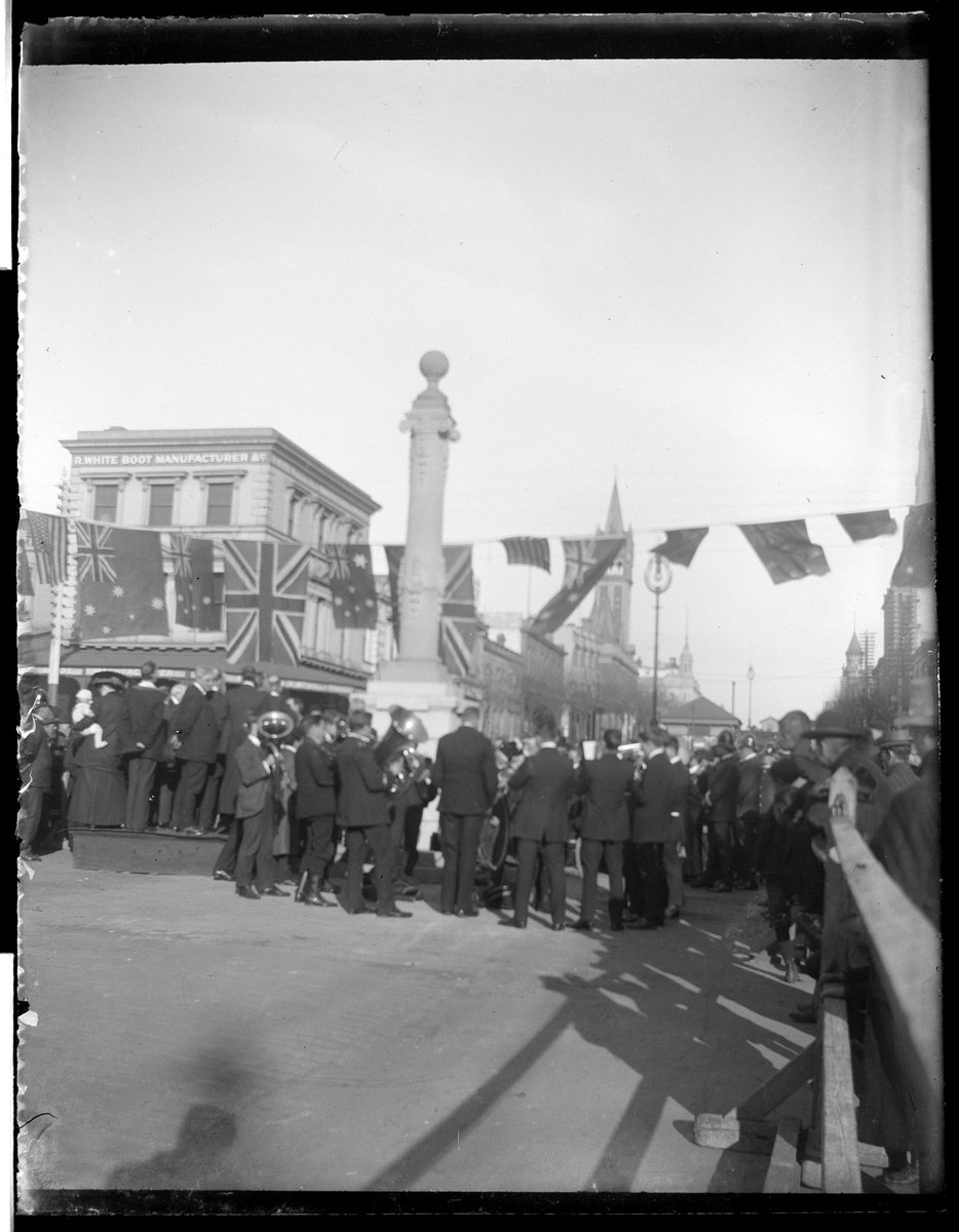 Crowd, including brass musicians on the corner of Bourke and Russell Streets, Melbourne City (1890–1910)
