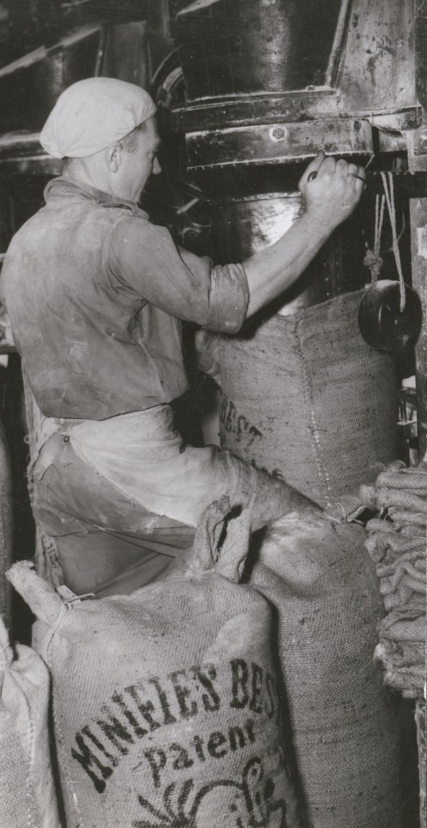 Filling sacks of flour at a Melbourne flour mill to help alleviate Britain's food shortage (c. 1946)