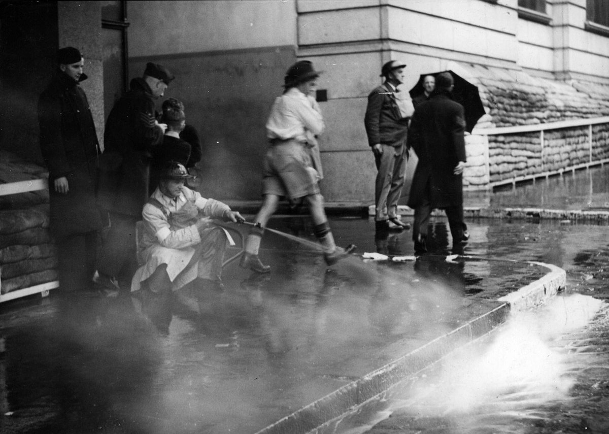 E. J. Plaistid hosing an 'incendiary' in Russell Street, Melbourne City (c. 1942)