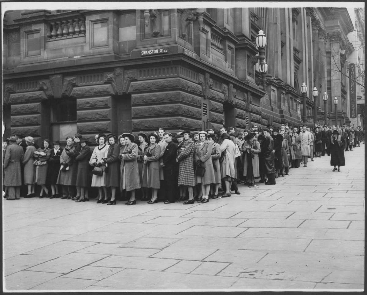 Long queue of people standing on the corner of Collins and Swanston Streets, Melbourne, Melbourne City (c. 1947)