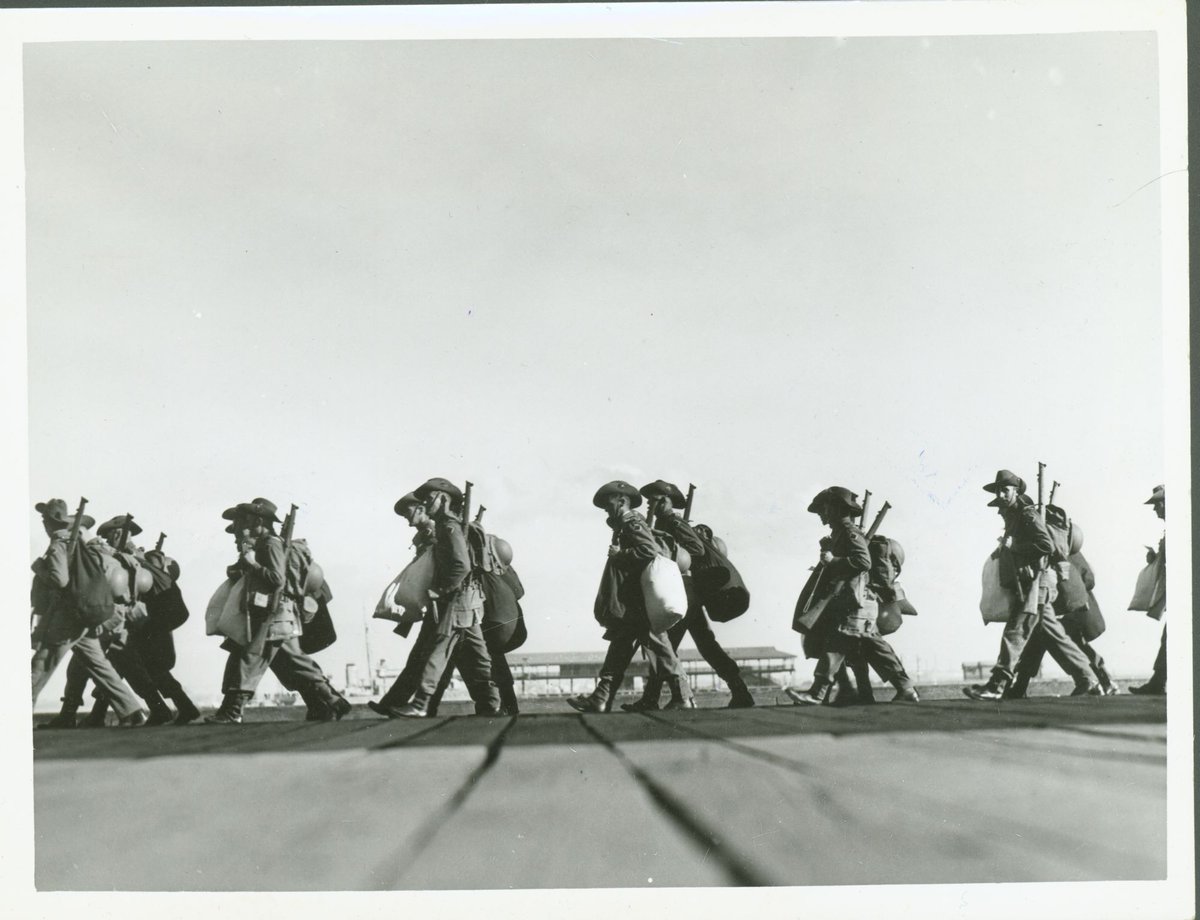 [Soldiers] marching along pier at Port Melbourne before embarking (1940)