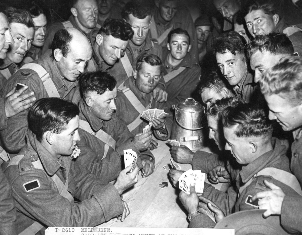 Card in hand and money on the table. A scene below decks on board an A.I.F. transport before leaving Melbourne (1940?)