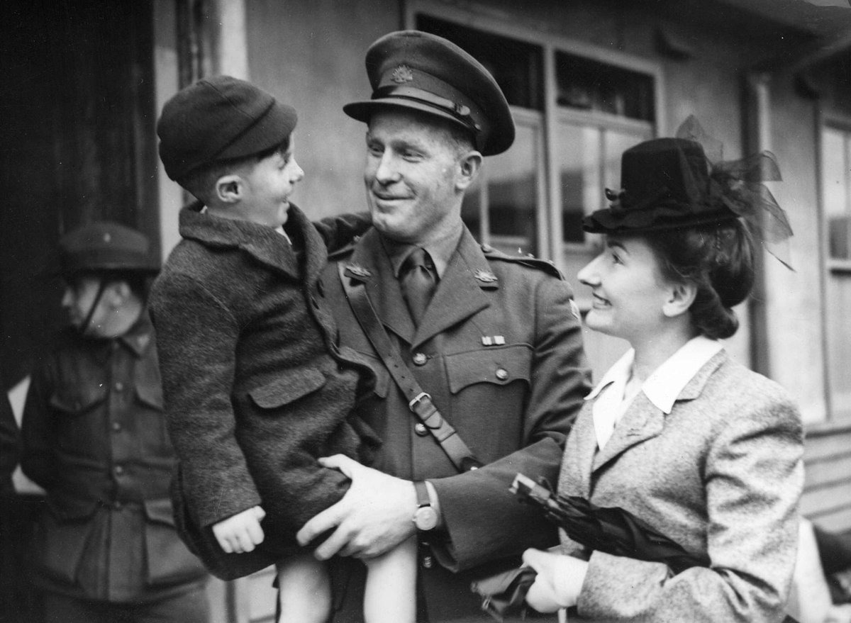 Escaped P.O.W. Royal Park. St. G. F. Mumford of Sunshine sees his son Jeff for the first time. On his right [left] is his wife, Parkville (c. 1945)