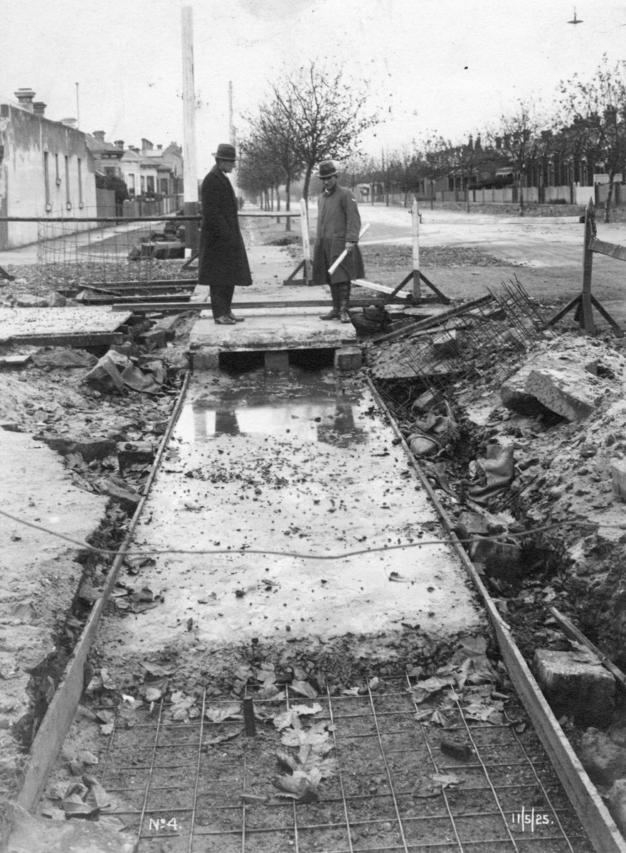 Men inspecting concreting for new electric tram construction, possibly in Richmond area (1925)
