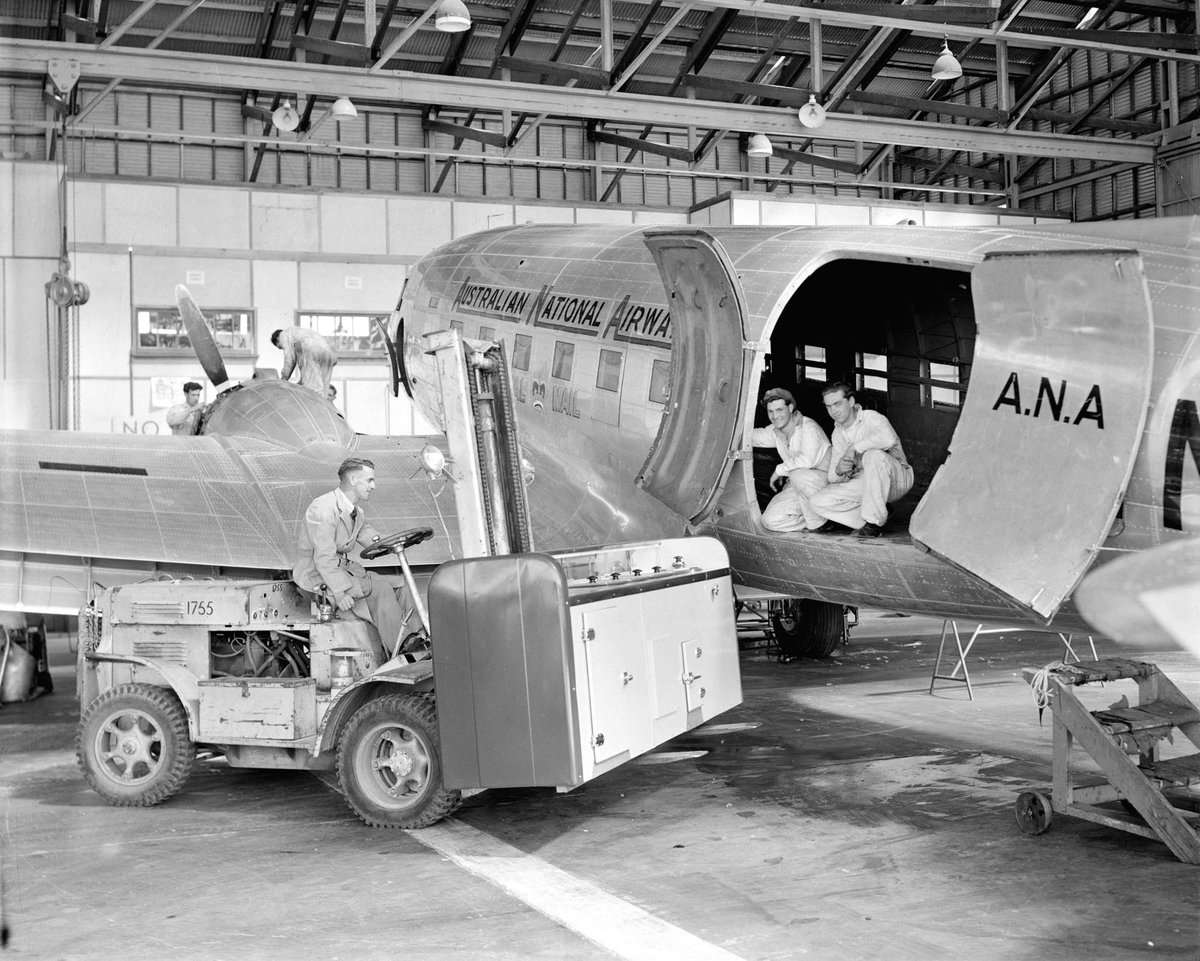 Interior of Australian National Airlines hangar at Essendon Airport, with ground crew, Essendon North (1949)
