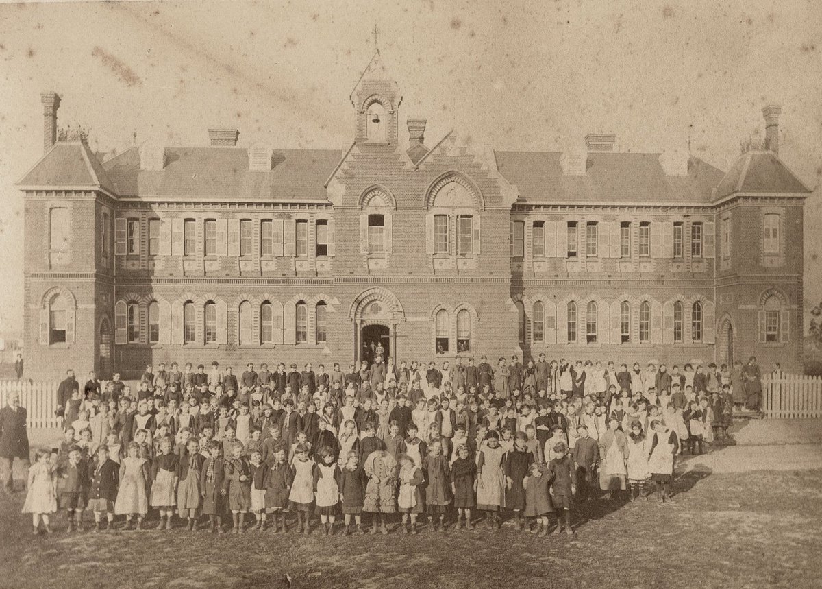 Female pupils and their teachers outside their school, Richmond Central State School, Gleadell Street, Richmond (1885–91)