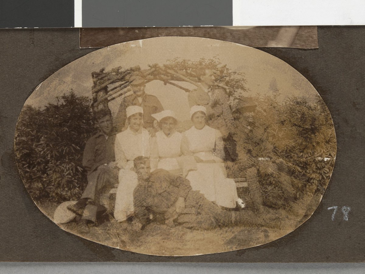 [Soldiers and nurses seated in front of rose arbour, Hethersett Private Repatriation Hospital, Burwood, Vic.] (1914–20)
