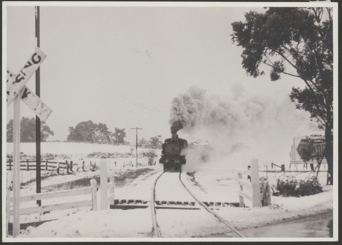 Heavy snowfalls around Melbourne, 1951 - steam train heading for Melbourne on Albury line near KalKallo