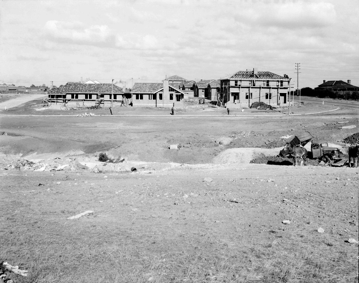 Houses under construction at Coburg Housing Estate, with Pentridge Prison? u.l. and tip truck and horses c.r (1945–49)