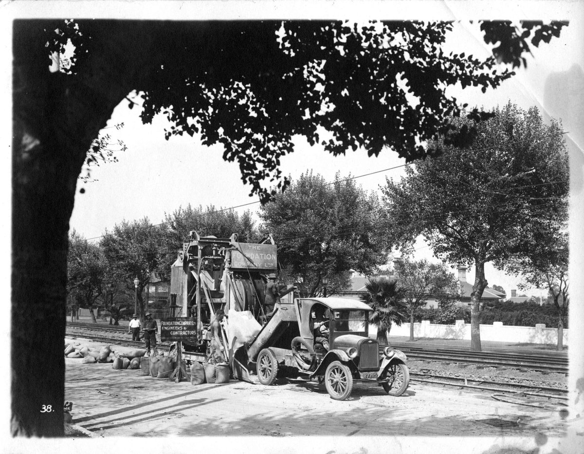 Foundation Company machinery and tip truck beside new tram track construction, possibly in St. Kilda Road, Melbourne City (c. 1925)