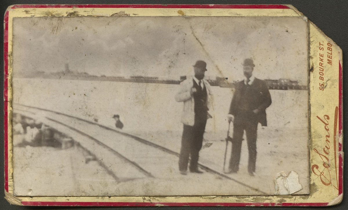 Two men standing beside the rail lines on a jetty, unidentified location, possibly Williamstown (1878–89)