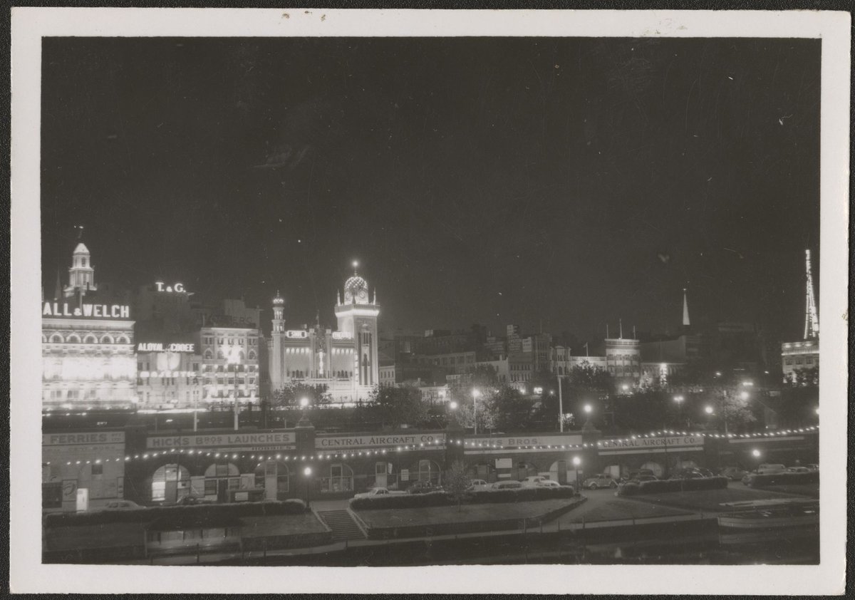 Night view of illuminated buildings in Flinders Street, Melbourne, Melbourne City (1954)