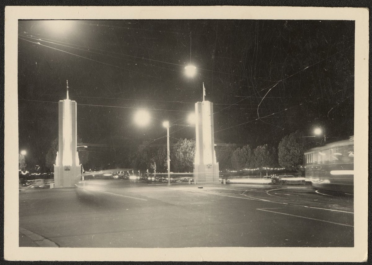 Night view of illuminated pylons on either side of St. Kilda Road, Melbourne, Melbourne City (1954)