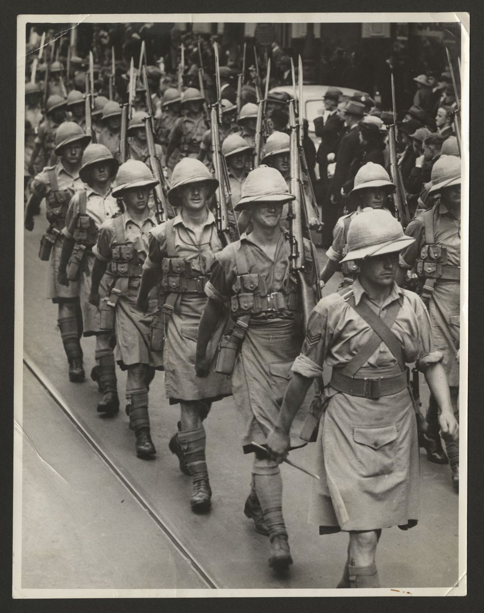 Men in tropical uniforms marching down a Melbourne street (1930–50)