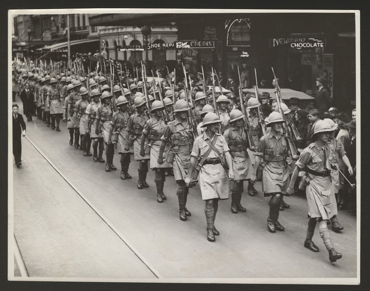 View of men in tropical uniforms marching down a Melbourne street (1930–50)