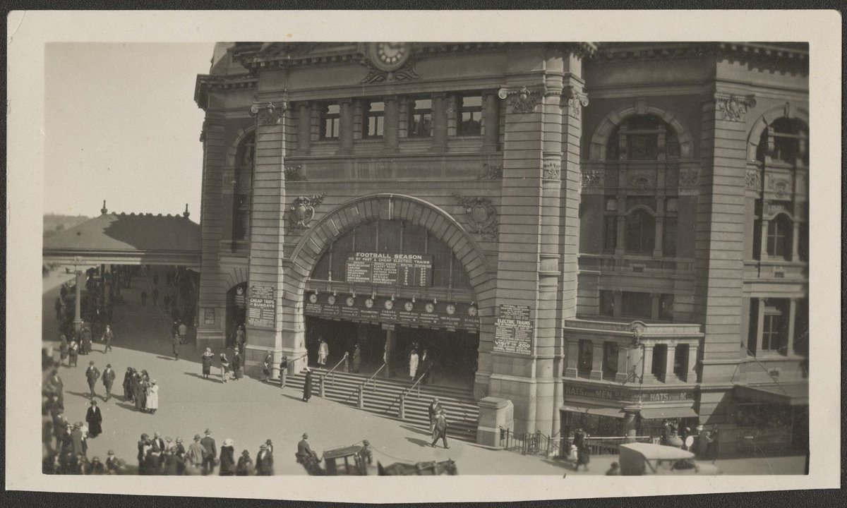 Elevated view of corner of Swanston and Flinders Streets, looking south west, showing entrance to the station in Melbourne, Melbourne City (1920s)