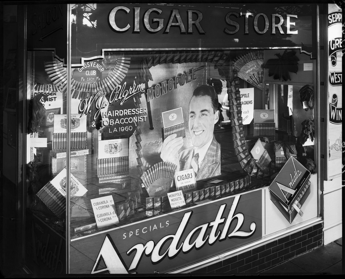 Tobacconist's and barber's display windows, 5 Fitzroy St., St. Kilda, St Kilda (1948)