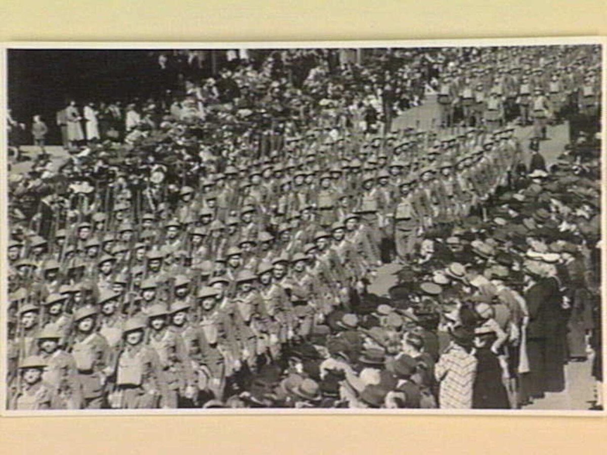 Marching six abreast these A.I.F. men swing along Swanston Street Melbourne ... to aid the Red Cross Victory V appeal, Melbourne City (1939–45)