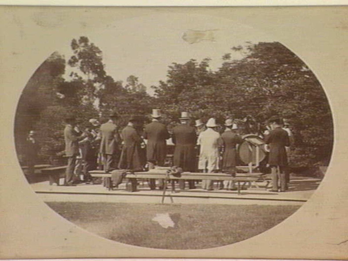 Musical band, approx. seventeen males, playing in Zoological Gardens, Melbourne, Parkville (c. 1900)
