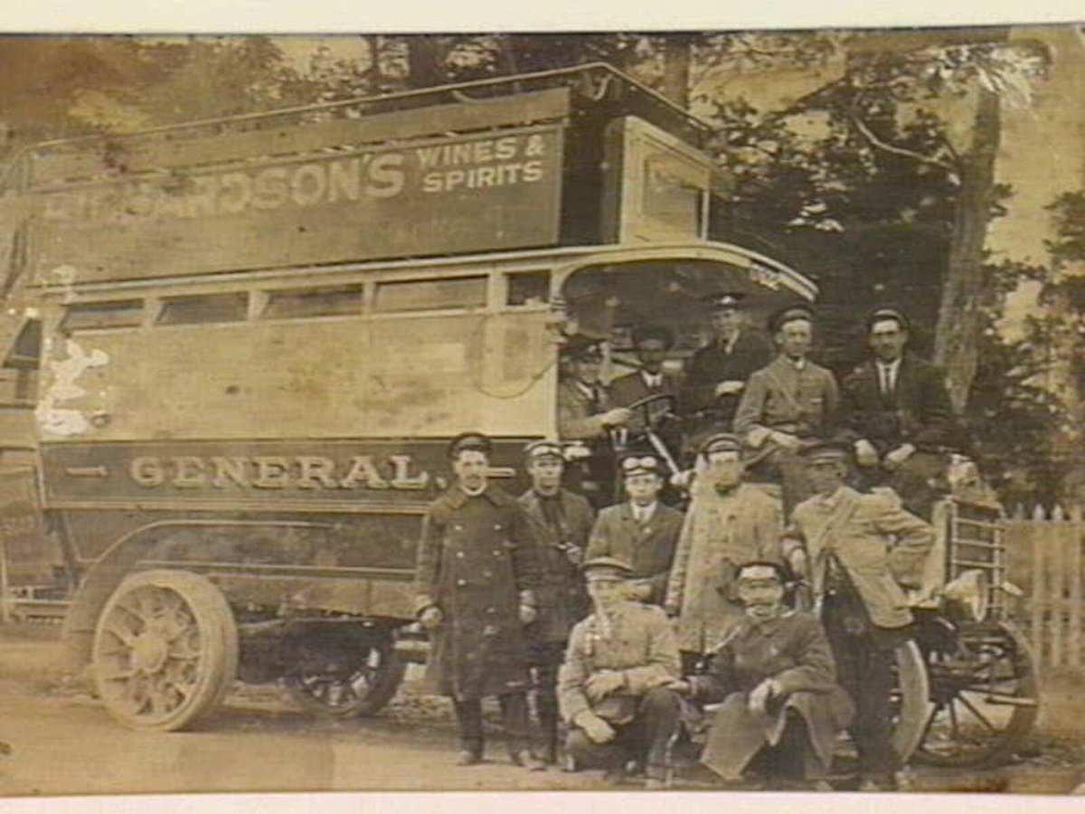 Double decker bus which operated along St. Kilda Road, employees on and in front of bus, Melbourne City (c. 1914)