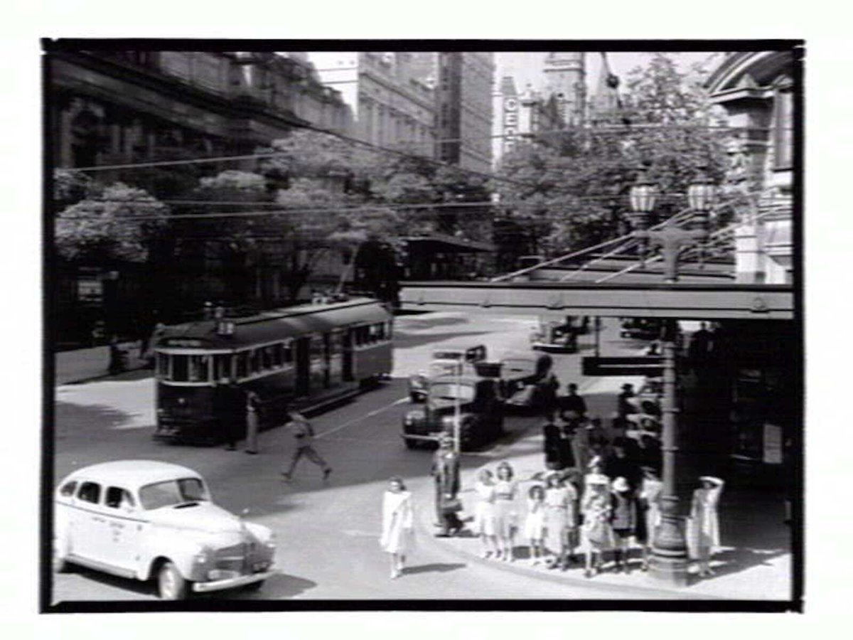 View of the corner of Swanston and Collins Streets, looking towards the Town Hall, Melbourne City (1936–39)