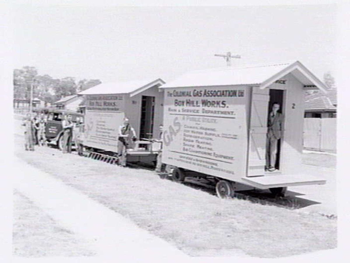 Workmen standing outside two Colonial Gas Association caravans from the Box Hill works (1937–40)