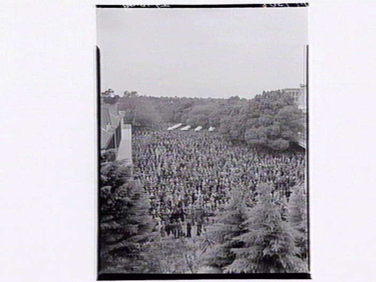 Large numbers of people placing bets at Flemington Racecourse (1949)